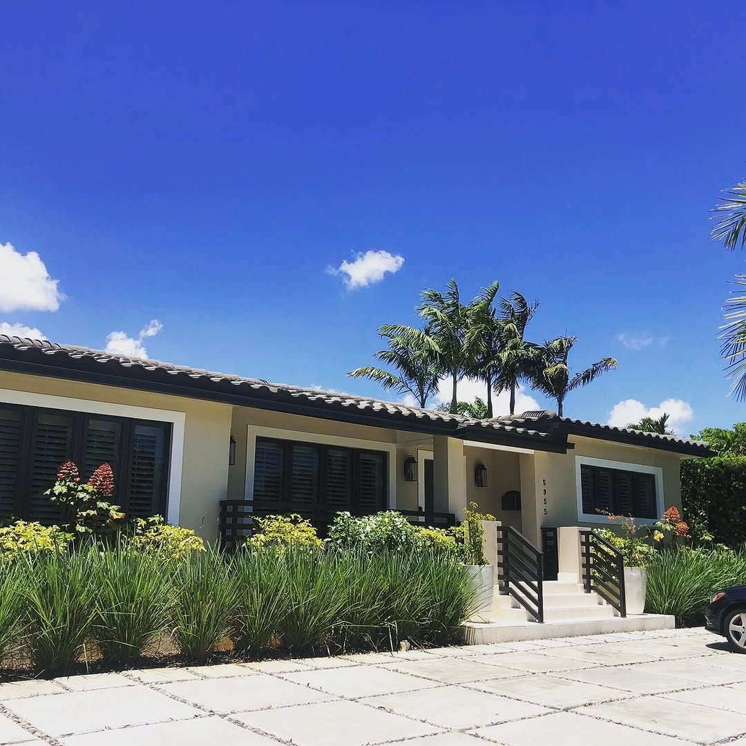 Renovated single-story home with palm trees and new landscaping